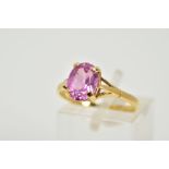 AN 18CT GOLD SAPPHIRE RING, designed with a single claw set oval cut pink sapphire to the