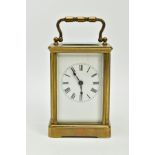A SMALL CARRIAGE CLOCK, within an open glass/brass case, white dial, Roman numerals, black hands,