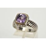 A SILVER AMETHYST RING, designed with a cushion cut amethyst within a collet mount with a rope twist