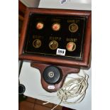 A WOODEN CASED WALL MOUNTED SERVANTS BELL CALL BOX, black glass lidded box with six circular clear