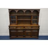 AN OLD CHARM OAK DRESSER with double lead glazed doors, four frieze drawers over two double cupboard