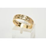 A 9CT GOLD FULL ETERNITY RING, the band with an engraved star detail, set with circular cut