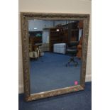 A MODERN GREY FINISH FRAMED BEVELLED EDGE WALL MIRROR, 133cm x 110cm