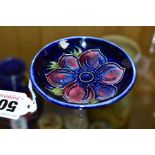 A MOORCROFT POTTERY PIN DISH, 'Anemone' pattern on blue ground, impressed backstamp, diameter