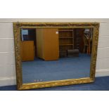 A LARGE LATE 20TH CENTURY FOLIATE GILT WOOD BEVELLED EDGE WALL MIRROR, 140cm x 110cm