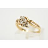 A YELLOW METAL DIAMOND RING, the asymmetrical lozenge shape set with eight round brilliant cut