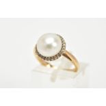 A YELLOW METAL PEARL AND DIAMOND RING, designed with a central cultured pearl, within a single cut