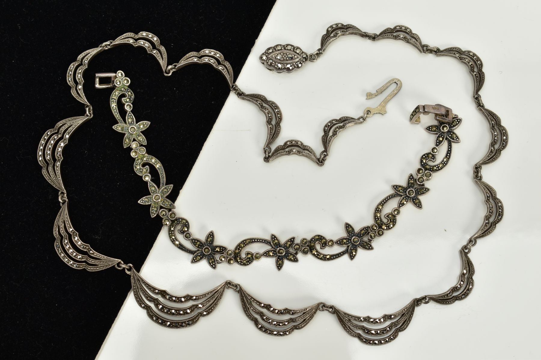 A MARCASITE NECKLACE AND BRACELET, the necklace designed with seventeen openwork marcasite drapped