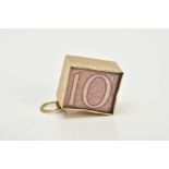 A 9CT GOLD CASED TEN SHILLING NOTE CHARM, the folded note within a plain polished square case and