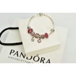 A MODERN PANDORA BANGLE, together with assorted charms, enamelled, glass floral designs in