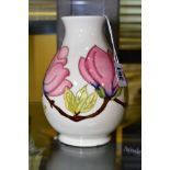 A MOORCROFT POTTERY VASE, 'Magnolia' pattern on white ground, impressed backstamp and WM to base,