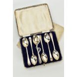 A CASED SET OF SIX GOLFING TEASPOONS, each plain polished teaspoon, embossed with golfing clubs