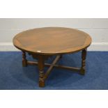 AN OLD CHARM OAK CIRCULAR COFFEE TABLE, on a cross stretchered base, diameter 99cm x height 48cm (