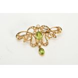 AN EARLY 20TH CENTURY GOLD PERIDOT AND SEED PEARL BROOCH, measuring approximately 35mm in length,