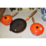 TWO LE CREUSET ORANGE ENAMEL SAUCEPANS WITH POURING LIPS AND LIDS, 16cm and 18cm diameter,