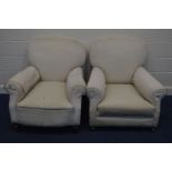 IN THE MANNER OF HOWARD AND SONS, a pair of early 20th Century cream upholstered armchairs, on bun