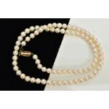 A CULTURED PEARL STRAND NECKLACE, each circular pearl approximately 5.0mm, on a white cord, fitted