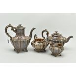 A FOUR PIECE SILVER TEASET, to include an elaborate foliate engraved wavy body of melon shape,