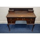 AN EDWARDIAN MAHOGANY LADIES DESK, with a brown leatherette top and seven various drawers, on