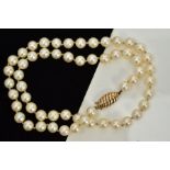 A CULTURED PEARL NECKLACE, each circular pearl measuring approximately 7.0mm, on a white cord fitted