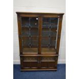 AN OLD CHARM OAK LEAD GLAZED TWO DOOR DISPLAY CABINET above double cupboard doors, width 108cm x