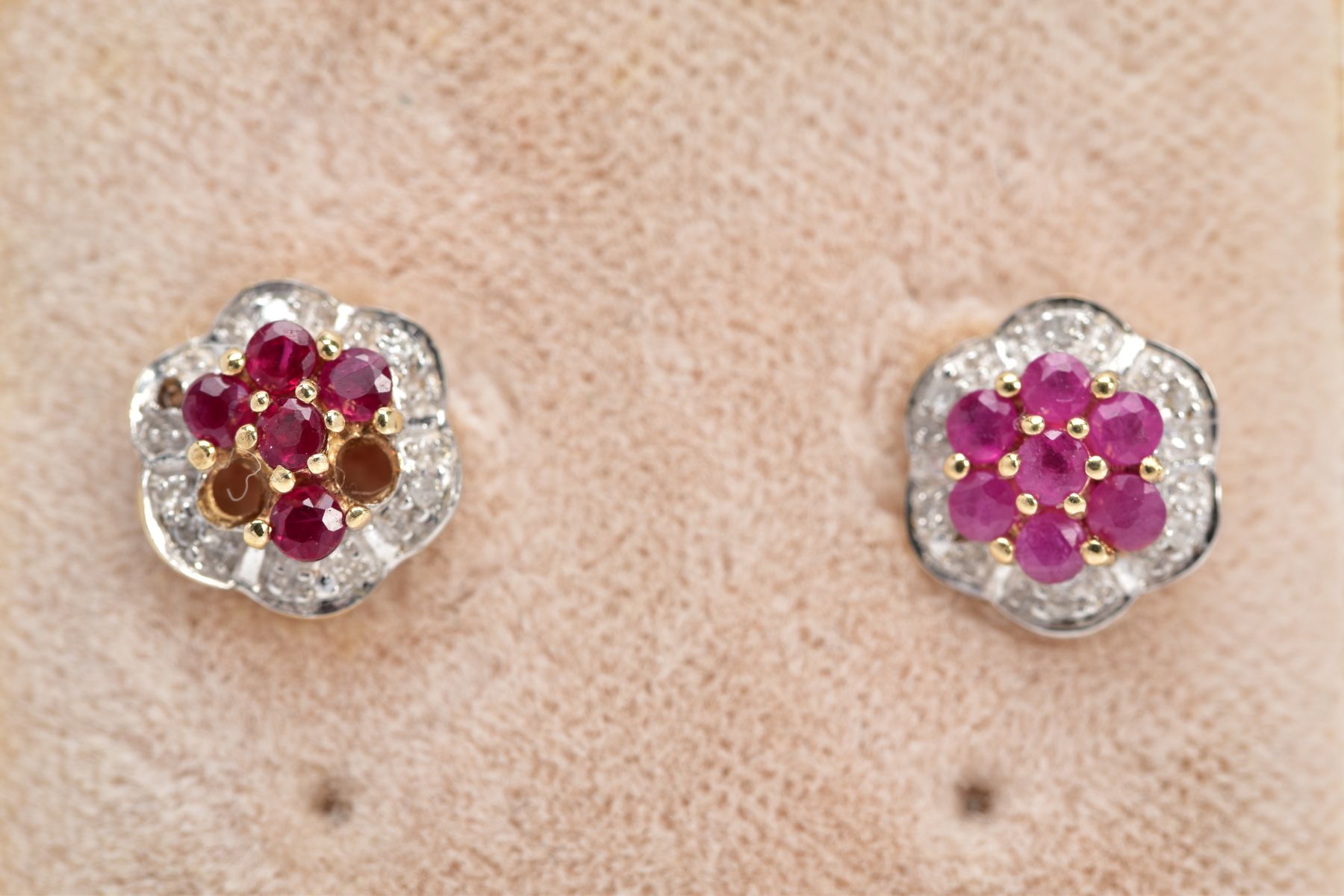 A PAIR OF 9CT GOLD RUBY AND DIAMOND EARRINGS, each of a flower design set with circular cut