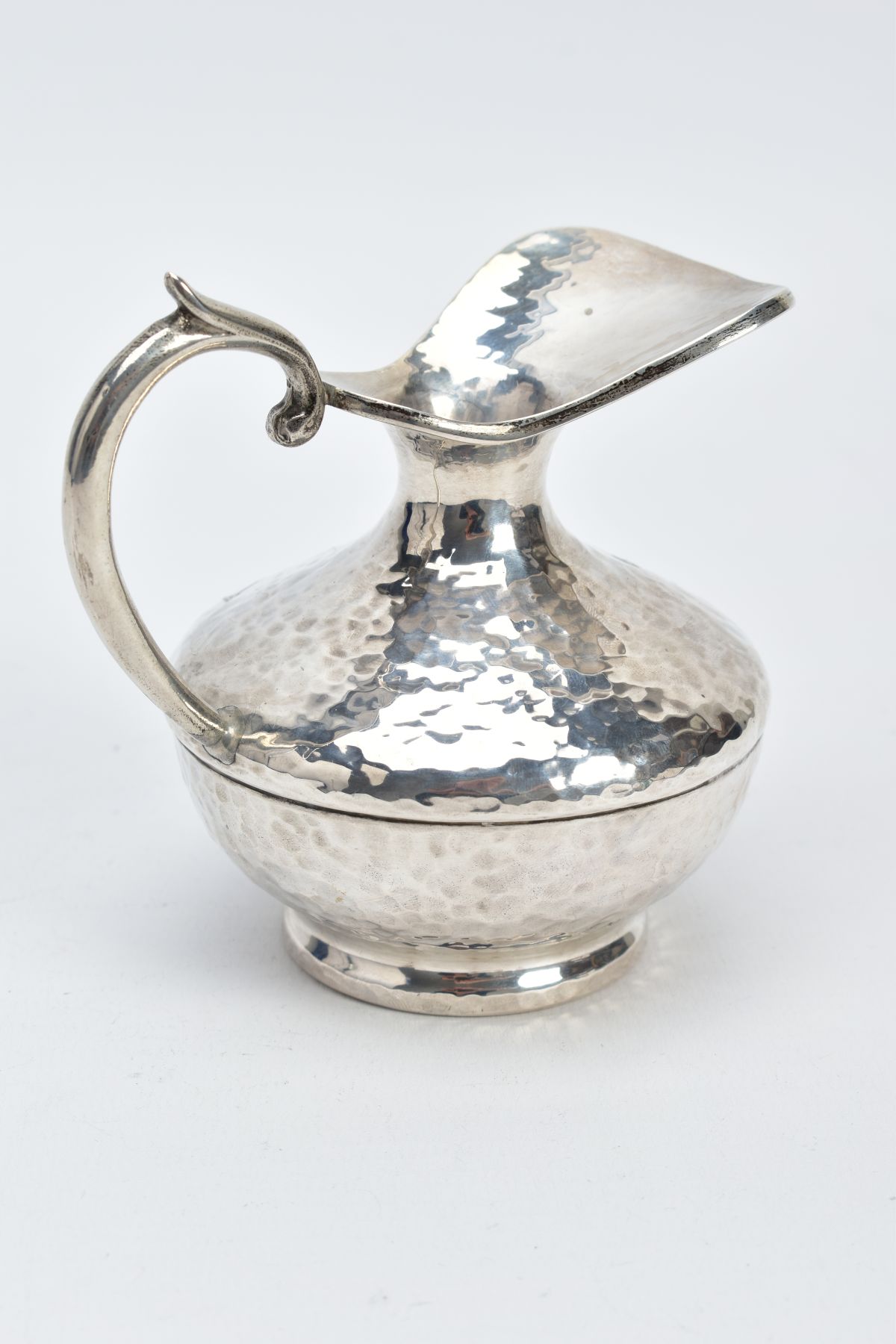 A WHITE METAL JUG, of a hammered design, scroll handle, stamped 925 to the base, approximate gross - Image 3 of 5