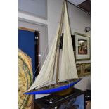 A SCRATCH BUILT MODEL YACHT, at full sail, the deck with rigging, etc, mounted on a rectangular