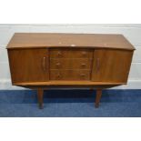 A MID TO LATE 20TH CENTURY TEAK SIDEBOARD with two cupboard flanking three central drawers, on