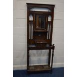 AN EARLY TO MID 20TH CENTURY OAK HALL STAND, with six metal hooks, central swinging mirror, single