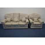 A FLORAL UPHOLSTERED TWO PIECE LOUNGE SUITE, comprising a three seater settee and an armchair (2)
