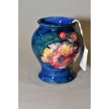 A SMALL MOORCROFT POTTERY VASE, 'Orchid' pattern on blue ground, impressed back stamp, height 8cm