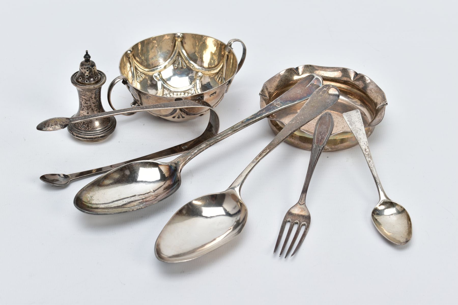 A QUANTITY OF SILVER ITEMS, to include a pair of Georgian bright cut sugar tongs, London 1805, two