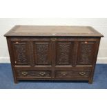 A GEORGIAN OAK MULE CHEST, plank top, elaborately carved with four stylised fielded panels, above