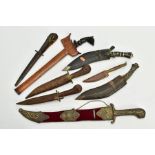 A COLLECTION OF DECORATIVE AND SOUVENIER DAGGERS, KUKRI, ETC, and a ebony handled dagger in a wooden