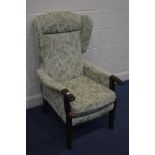 A STAINED BEECH AND FLORALLY UPHOLSTERED WING BACK ARMCHAIR
