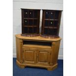 A PINE CORNER TV STAND , with a pull out slide above double cupboard doors, width 121cm x depth 53cm