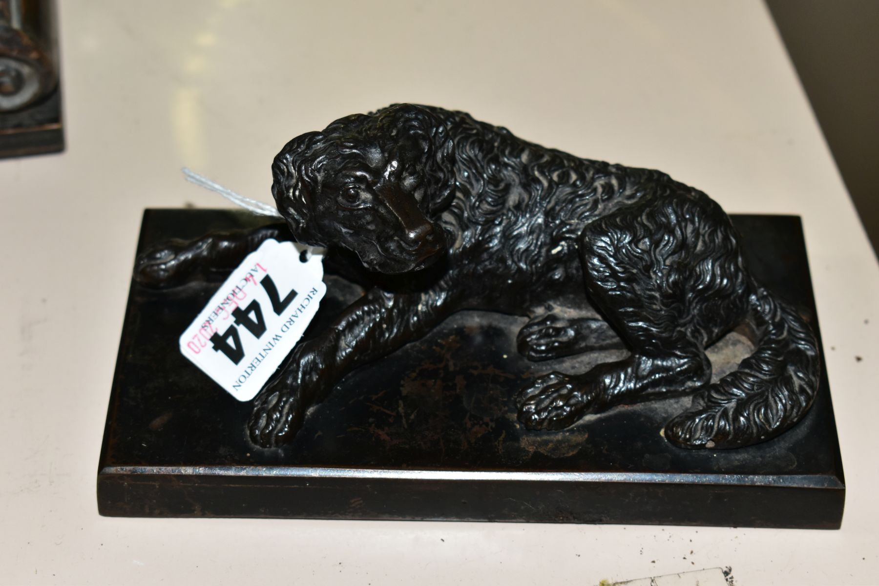 A BRONZED CAST METAL SCULPTURE OF A DOG LYING DOWN (Retriever), mounted on a rectangular bronzed