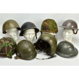 A LARGE BOX OF EIGHT MILITARY STEEL HELMETS as follows: British grey painted dated 1941 with liner