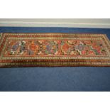 A KAZAK CARPET RUNNER, late 19th century or earlier, in multiple colours, 398cm x 111cm (frayed