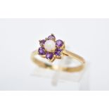 A 9CT GOLD OPAL AND AMETHYST CLUSTER RING, set with a central opal cabochon, within a circular cut