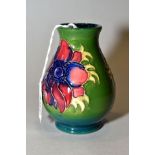 A SMALL MOORCROFT POTTERY VASE, 'Anemone' pattern on green ground, impressed backstamp, height 10cm