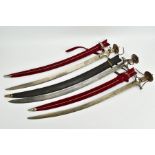 THREE MIDDLE EASTERN/ASIAN CURVED SWORDS, two have red/wood scabbards and look to be cruedly made '