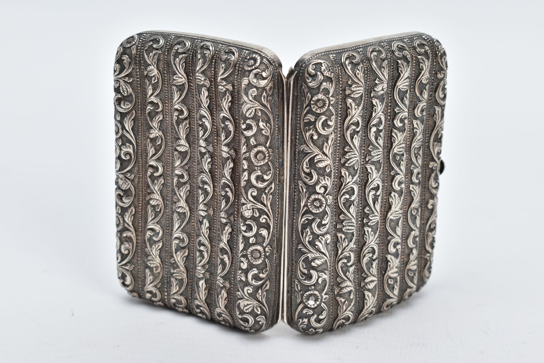 A WHITE METAL ORNATE CASE, of a floral and foliate embossed design, fitted with a push button clasp, - Image 2 of 3