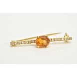 AN 18CT GOLD DIAMOND AND CITRINE BAR BROOCH, designed with a claw set oval cut Citrine, to a round