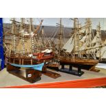 FOUR WOODEN MODEL SHIPS, all on display stands, one named 'Cutty Sark', the largest height