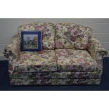 A FLORAL UPHOLSTERED TWO SEATER BED/SETTEE