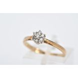A 9CT GOLD DIAMOND CLUSTER RING, designed with a small cluster of seven round brilliant cut