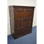 AN OAK PANELLED TWO DOOR WARDROBE, width 129cm x depth 57cm x height 164cm (missing base)