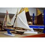 THREE MODEL YACHTS ON DISPLAY STANDS, including a model of a Skipper yacht, approximate height 68.